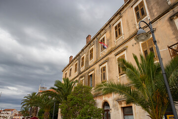 Stari Grad/Croatia-August 7th,2020: Beautiful, worn out facade of old house on the edge of waterfront in the oldest town on Hvar island, Croatia, under the cloudy sky