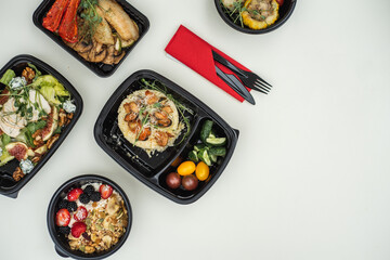 Sat of take away boxes with healthy food on the white background. Restaurant dishes. Flat lay