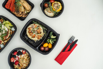 Sat of take away boxes with healthy food on the white background. Restaurant dishes. Top view. Flat lay.