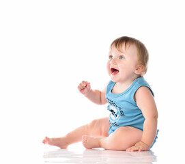 Baby toddler pleasantly surprised looking up on a white background.