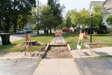 Fototapeta premium Suburban Neighborhood Sidewalk under Construction Barriers 