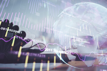 Double exposure of financial chart drawing and desktop with coffee and items on table background. Concept of forex market trading