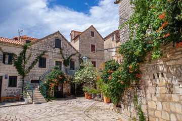 Fototapeta na wymiar Stari grad/Croatia-August 5th,2020: Beautiful traditional stone houses at the Stari Grad, oldest town on Hvar island, populat tourist destination