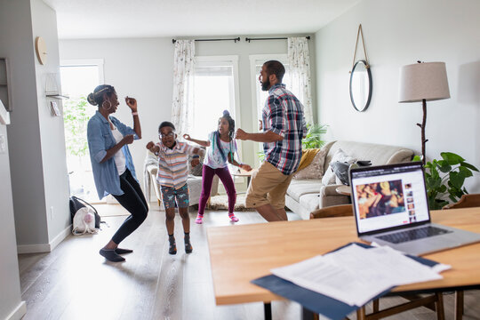 Happy family enjoying dance party in living room