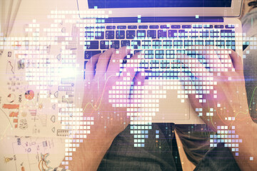 Double exposure of man's hands typing over computer keyboard and business theme hologram drawing. Top view. Financial markets concept.