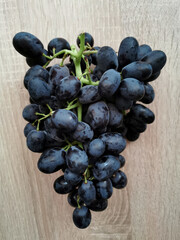 Dark ripe grapes on a wooden table