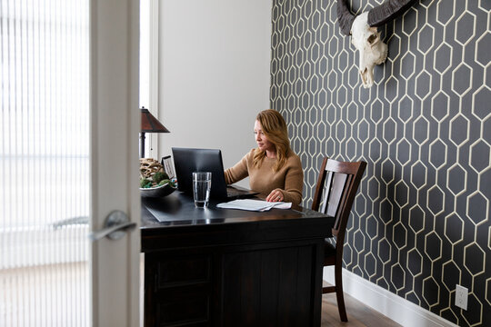 Woman Using Laptop In Home Office