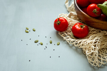 Healthy food vegetables on grey background. Groceries in recycle textile bags. Eco friendly plastic free low waste lifestyle. Zero waste bio food storage and shopping concept.