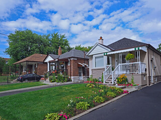Street with row of modest 1950s style working class bungalows