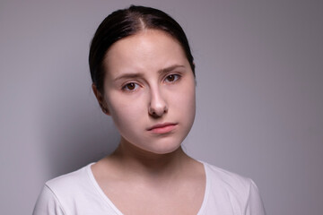  portrait of sad and depressed young woman. on gray background. nervous and upset people concept.