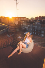Caucasian young girl enjoying sunset with a roofview over Donostia-San Sebastian, Basque Country.