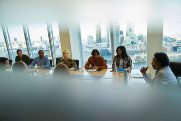 Business people talking in highrise conference room meeting