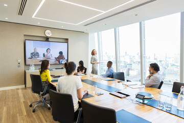 Business people video conferencing in conference room meeting
