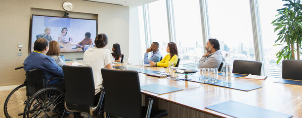 Business people video conferencing in conference room meeting