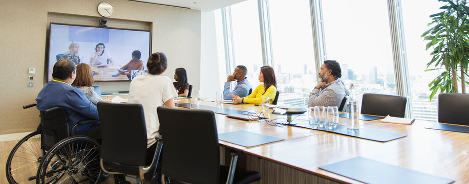 Business people video conferencing in conference room meeting - Powered by Adobe
