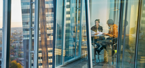 Business people meeting at highrise office window