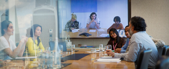 Business people video conferencing in conference room meeting
