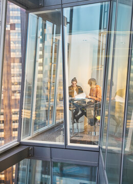 Business people meeting at modern highrise office window