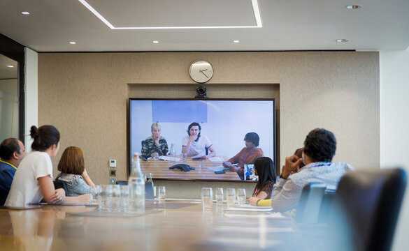Business people video conferencing in conference room meeting