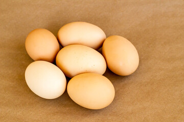 Organic,fresh large size uncooked eggs on kraft paper surface,top view