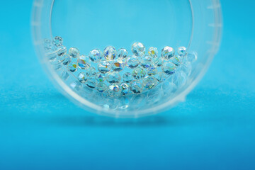 Fototapeta na wymiar transparent beads and blue background