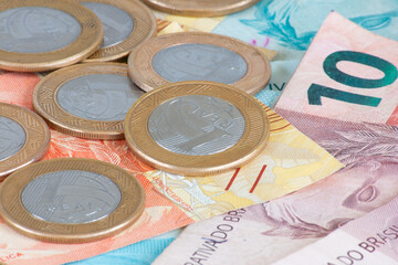 Brazilian money. Coins and money bills of different values stacked. Finance concept.