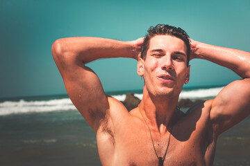 Young man posing at Ilbarritz beach, in Biarritz, Basque Country.