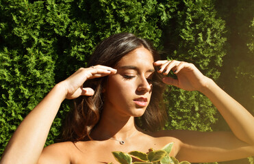 young woman in the park with a headache