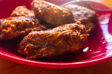Fried vegetable fritters with zucchini, carrots, herbs, eggs, and cheese.