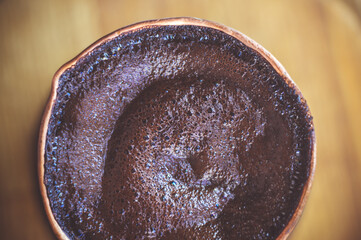 Natural coffee with thick foam, brewed in a copper cezve in the classical way, on a wooden...