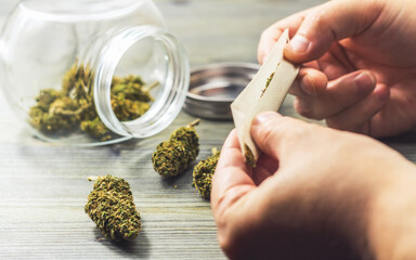 Close up hands rolling a Cannabis Joint