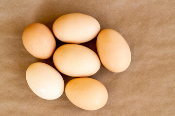 Organic,fresh large size uncooked eggs on kraft paper surface,top view