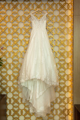 Wedding dress hanging from wall
