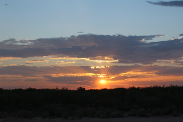 View of the West Texas desert landscape during a beautiful sunset behind some clouds.