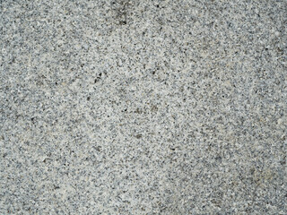 The texture of a granite stone. Top-down close-up view.