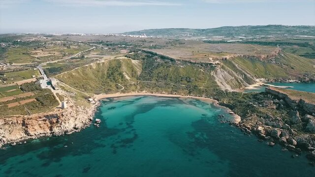 Għajn Tuffieħa Tower and the bay  with wite sand beach on Malta from high above by drone.