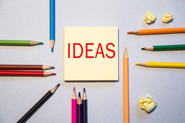 note with Flat lay space for text. The words ideas . Office, colored paper, colored pencils....