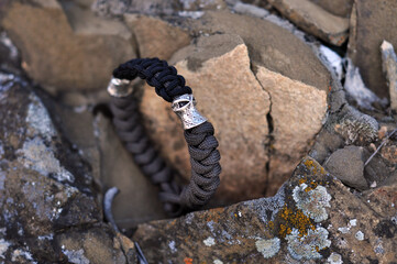 A braided paracord bracelet combined on a standing chip with a metal ninja bead