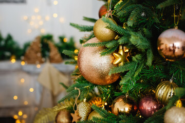 Christmas decorations on evergreen tree branches with shining garlands. Selective focus.