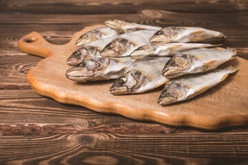 Dried fish on a wooden background. Studio photo.