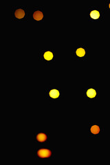 yellow blurred lights on a black background. abstract colorful bokeh glow for entourage.