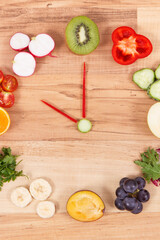 Clock made of fruits and vegetables showing time 10 am, time for healthy breakfast concept
