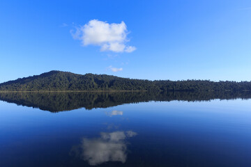 Calm mirror lake in the morning with mountain background in New Zealand.