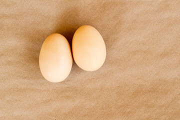 Organic,fresh large size uncooked eggs on kraft paper surface,top view