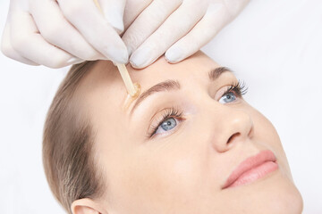 Hot hair removal depilation. Female skin routine. Sugar bodycare. Wax Eyebrow correction....