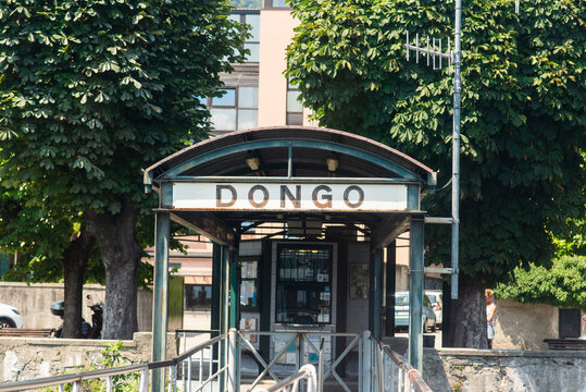 Dongo. Lake Como. Italy - July 21, 2019: Ferry Pier in the Commune of Dongo. Lombardy. Signboard with Name of the City.