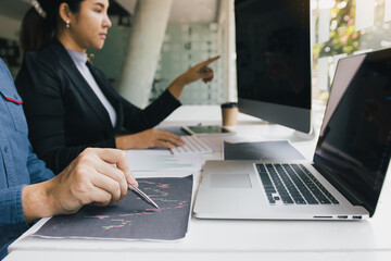 Two business stock brokers stress and looking at monitors displaying financial stock graph report information.