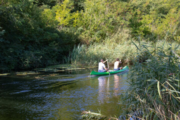 two men rowing down the river in Sombor, Serbia