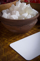 Candied coconut fruits in a clay bowl