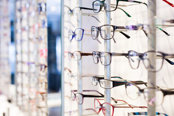 Image of glasses showcase at a modern optic shop, nobody